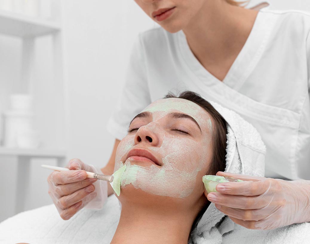 Beautician doing facial to a customer